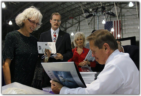 SR-71 pilot Brian Shul autographs copies of his book,